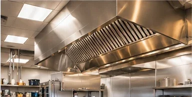 Commercial kitchen with a stainless steel exhaust hood